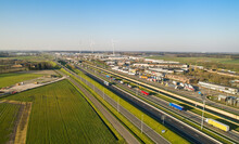 Aerial View Of A Motorway, A Border Point With Traffic Queuing To Cross The Dutch Belgian Border. 