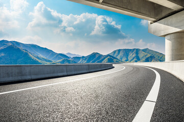 Asphalt highway and green mountains in summer.