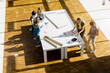 © Connect Images - High angle view of group of young architects working on an architectural model.