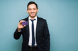 © AntonioDiaz - Good-looking man holding a purple credit card