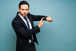 © AntonioDiaz - Upset latin man telling the time against a blue background
