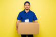 © AntonioDiaz - Latin happy man smiling while making a delivery