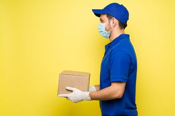 Wall Mural - Man with a face mask working as a delivery courier