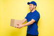 © AntonioDiaz - Cheerful hispanic man holding a cardboard box