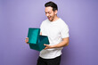 © AntonioDiaz - Portrait of a cheerful happy man opening a gift box