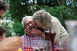 © Connect Images - Senior woman kissing husband on cheek