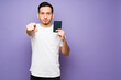 © AntonioDiaz - Handsome showing his passport in a colorful background