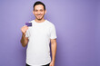 © AntonioDiaz - Hispanic man with a beaming smile showing his credit card