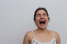Photo Taken On White Background In Studio Of Woman Screaming With Eyes Closed