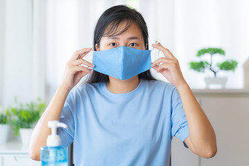 Asian woman wearing handmade protective face mask protect against coronavirus covid-19 spreading..