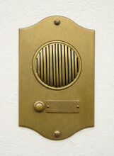 Old Bronze Door Intercom Buzzer. Vintage Golden Buzzer On A White Concrete  Wall