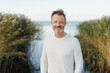 © contrastwerkstatt - Friendly cheerful bearded middle-aged man at the seaside