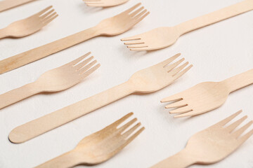 Wooden forks on light background