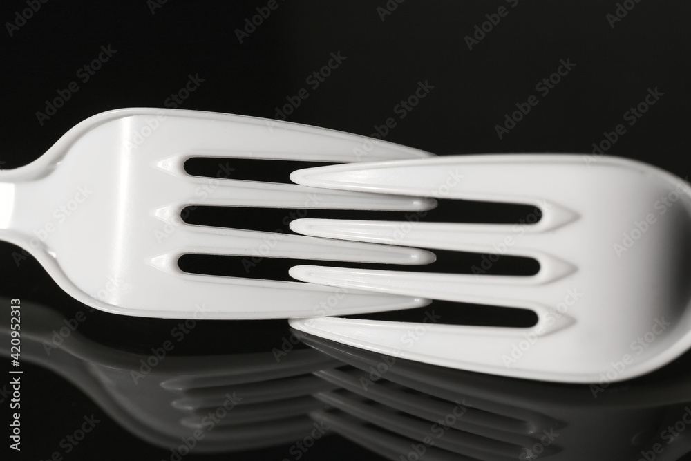 Plastic forks on dark background