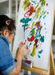 © Bangkok Click Studio - Asian girl with Down syndrome showing paint