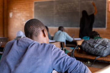 boy attending class in a school in a rural the gambia