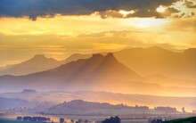 SPECTACULAR DRAKENSBERG SKIES. Light Refracts Into Yellow And Blue Along The Egde Of Cloud Bank. Drakensberg, South Africa