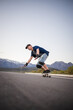 © Dewald - Skateboarder skateboarding on an open road doing freestyle tricks
