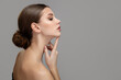 © Alena - Woman face profile side view. Chin lift pointing with index finger