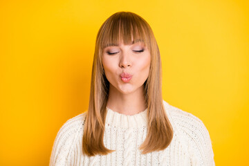 Poster - Portrait of adorable positive lady closed eyes kiss lips wearing pullover isolated on bright yellow color background