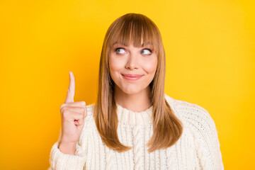 Canvas Print - Photo of adorable person look indicate finger up empty space good mood wear sweater isolated on yellow color background