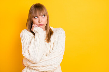 Canvas Print - Portrait of unsatisfied sullen lady hand on cheek look empty space wear warm pullover isolated on yellow color background