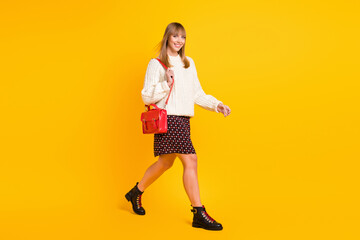 Poster - Full body profile photo of satisfied gorgeous lady walking look camera isolated on yellow color background