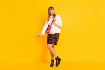 Wall Mural - Full length portrait of adorable young person look empty space toothy smile isolated on yellow color background