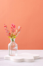 Vertical Image.Glass Vase And White Podium For Product Show On The White Table Against Orange Wall