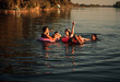 © Zoran Zeremski - Friends enjoying a summer day swimming at the lake.