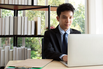 Smart asian businessman working with laptop at office.