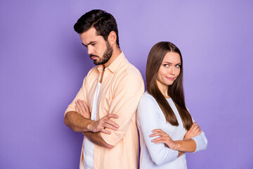 Poster - Photo of unhappy couple guilty woman sad man folded hands stand back to back isolated on purple color background