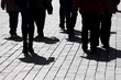 © Oleg - Silhouettes and shadows of people walking on the city street. Concept of society or population
