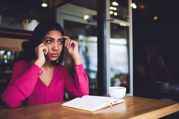 Wall Mural - Serious black woman calling on smartphone in cafeteria