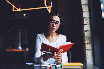 Wall Mural - Calm black woman reading book during break