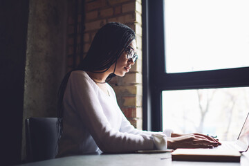 Canvas Print - Concentrated black woman freelancer working on project on laptop