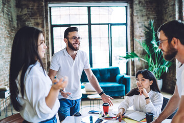 Wall Mural - Group of diverse colleagues discussing project in loft