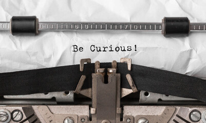 Poster - text be curious typed on retro typewriter