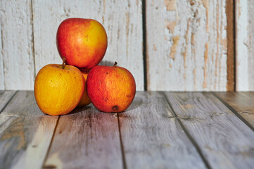 Wall Mural - Apples lit from the sun decoratively lying on a wooden underground.