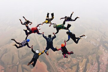 Skydivers holding hands making a fomation. High angle view.