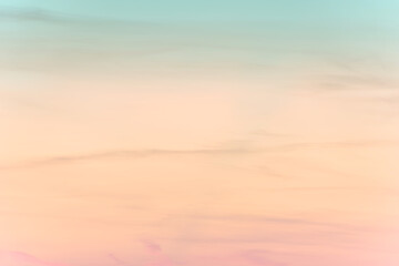 Wall Mural - sunset background. sky with soft and blur pastel colored clouds. gradient cloud on the beach resort.