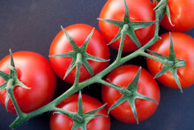 Close-up Of Some Ripe Tomatoes On The Vine