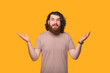 © Vulp - Photo of confused bearded hipster man gesturing over yellow background
