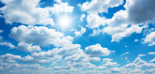 blue sky with clouds and sun.