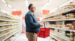 © Ljupco Smokovski - Man with a shopping basket looking at a supermarket shelf