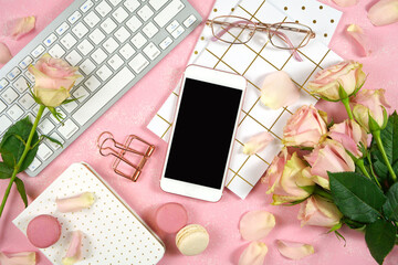 Wall Mural - Desktop workspace smart phone mockup, blush pink roses on pink background.