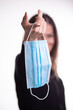 © Adam Radosavljevic - Happy woman takes off medical protective mask holds it on her finger, enjoys life, clean fresh air after Covid-19 pandemic, self-isolation. Quarantine is over.