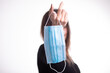 © Adam Radosavljevic - Happy woman takes off medical protective mask holds it on her finger, enjoys life, clean fresh air after Covid-19 pandemic, self-isolation. Quarantine is over.