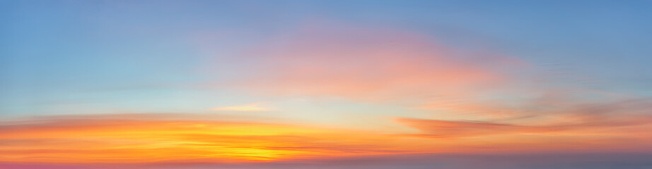 Wall Mural - scenic golden orange clouds against azure sky just before sunrise. panoramic shot of bright dawn sky
