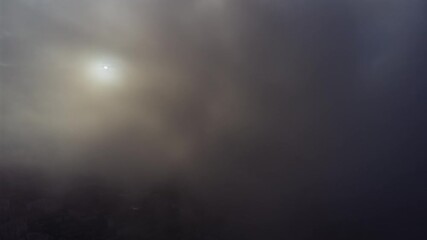 Wall Mural - amazing flight through moving clouds towards bright shining sun. view from airplane window to beauti